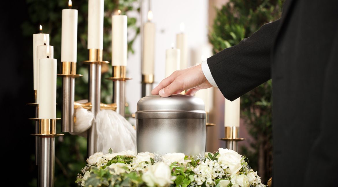 Urna di metallo a un funerale con le candele